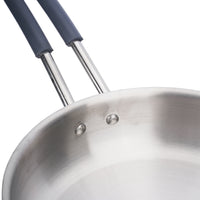 Close-up of a stainless steel frying pan with blue handles on a white background