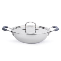 Stainless steel wok with glass lid and blue handles on a white background