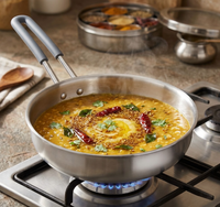 Stir-fry dish in a pan on a gas stove with spices in the background