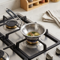 Stainless steel frying pan on a gas stove with ingredients being cooked.